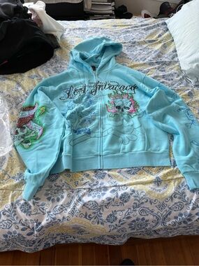 Lost Intricacy Ed Hardy Light Blue Graphic Zip-Up Hoodie with Skull Design